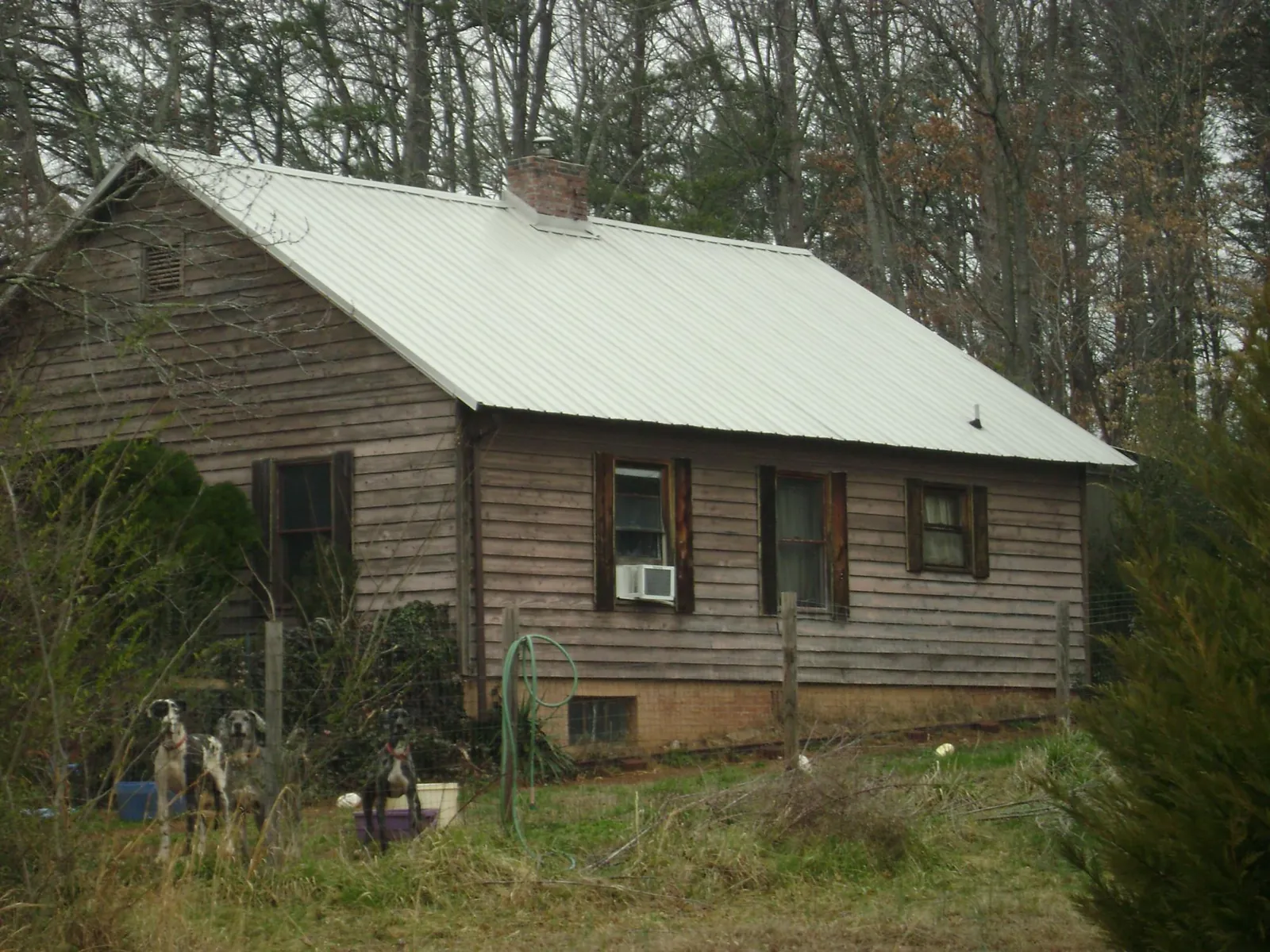 White metal roof on an old wood sided farmhouse, from a Metal Roof Installation job in Laguna Woods